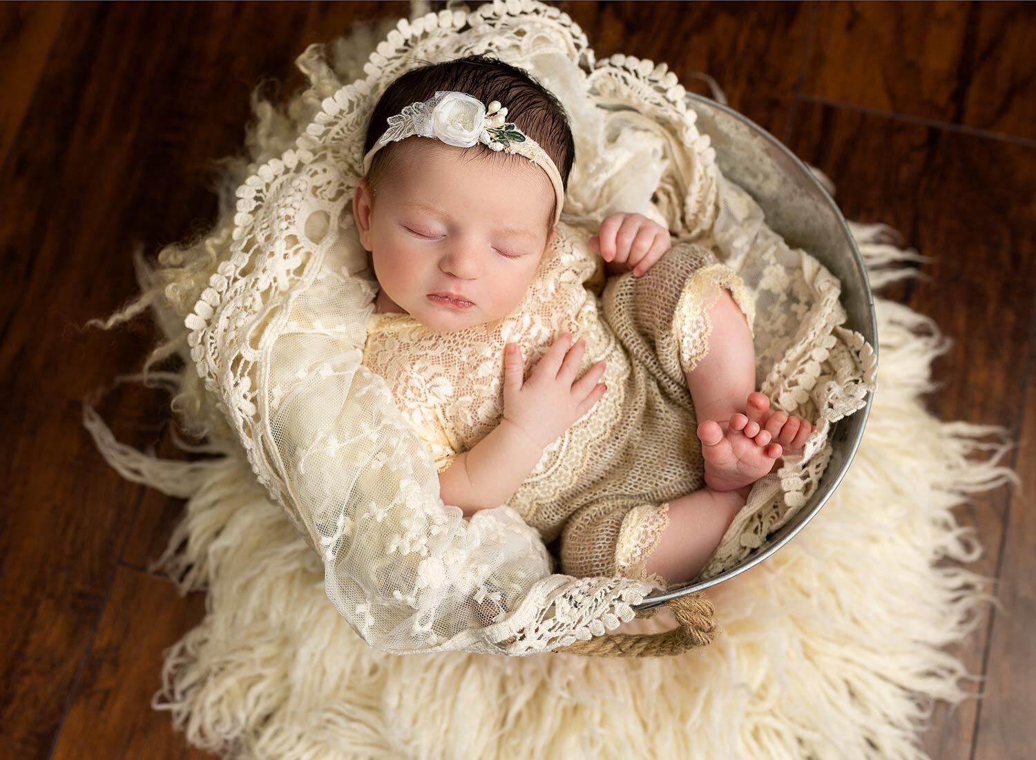 baby posed sleepinig in basket NJ
