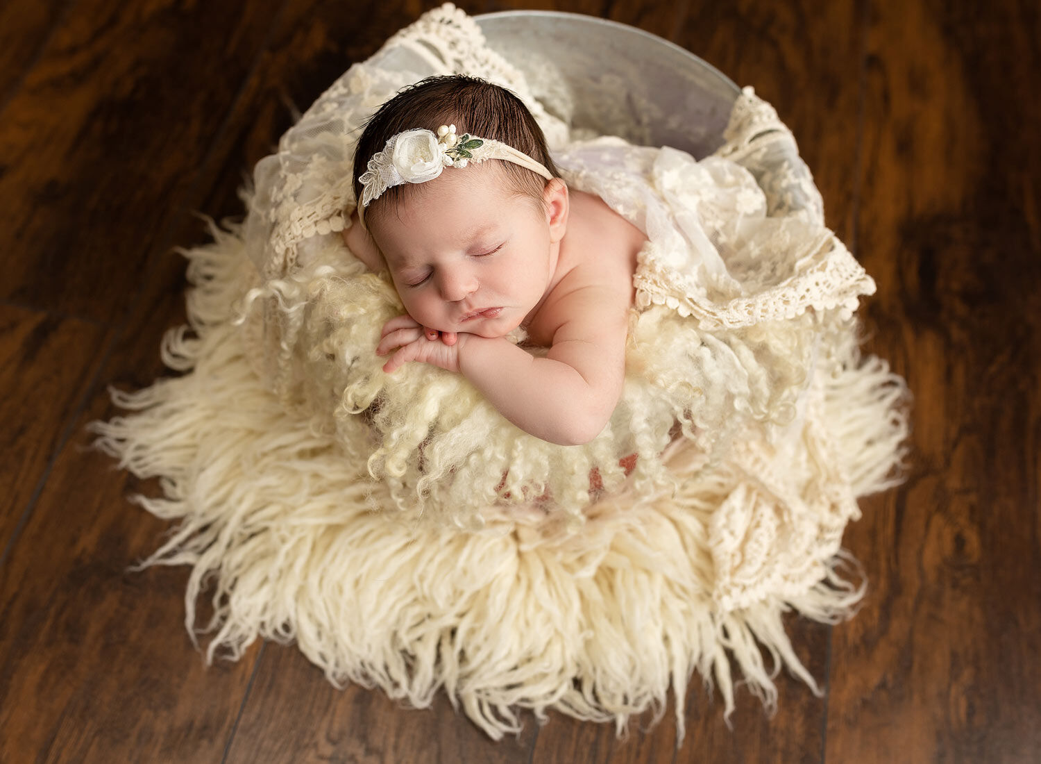 newborn posed in a buckeet photo