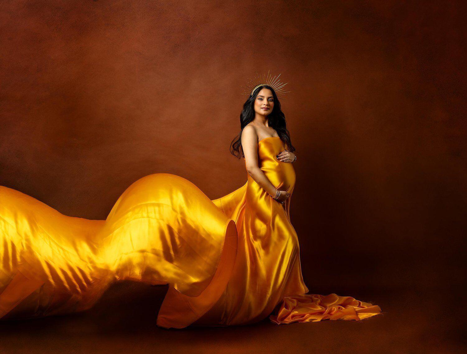 best new jersey maternity photographer new jersey maternity photo of mom to be wearing a gold flowing fabric