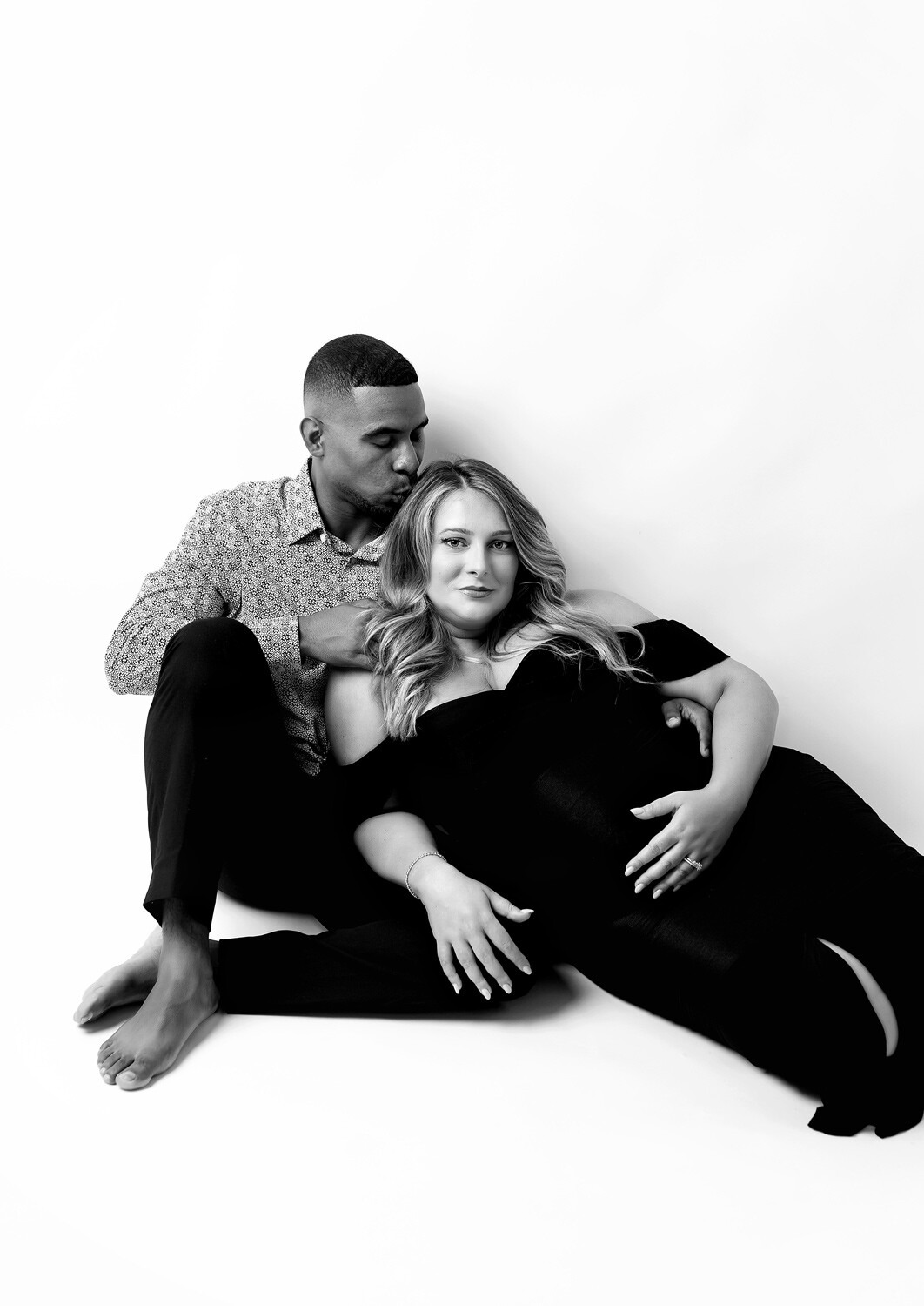 Dover NJ Pregnancy photo shoot in studio Dover NJ pregnancy photo shoot studio, couple dressed elegant sitting on floor