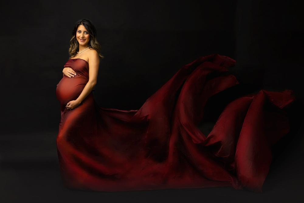 Pregnancy Photo shoot of mom wearing red chiffon scarf in studio