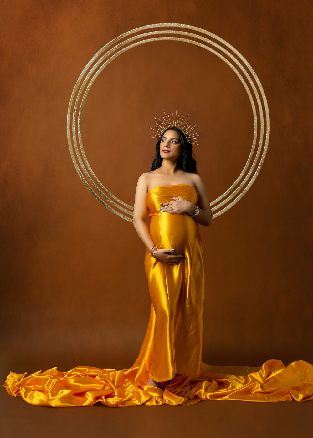 A Maternity picture of Mom showing baby bump on satin yellow fabric Morris County