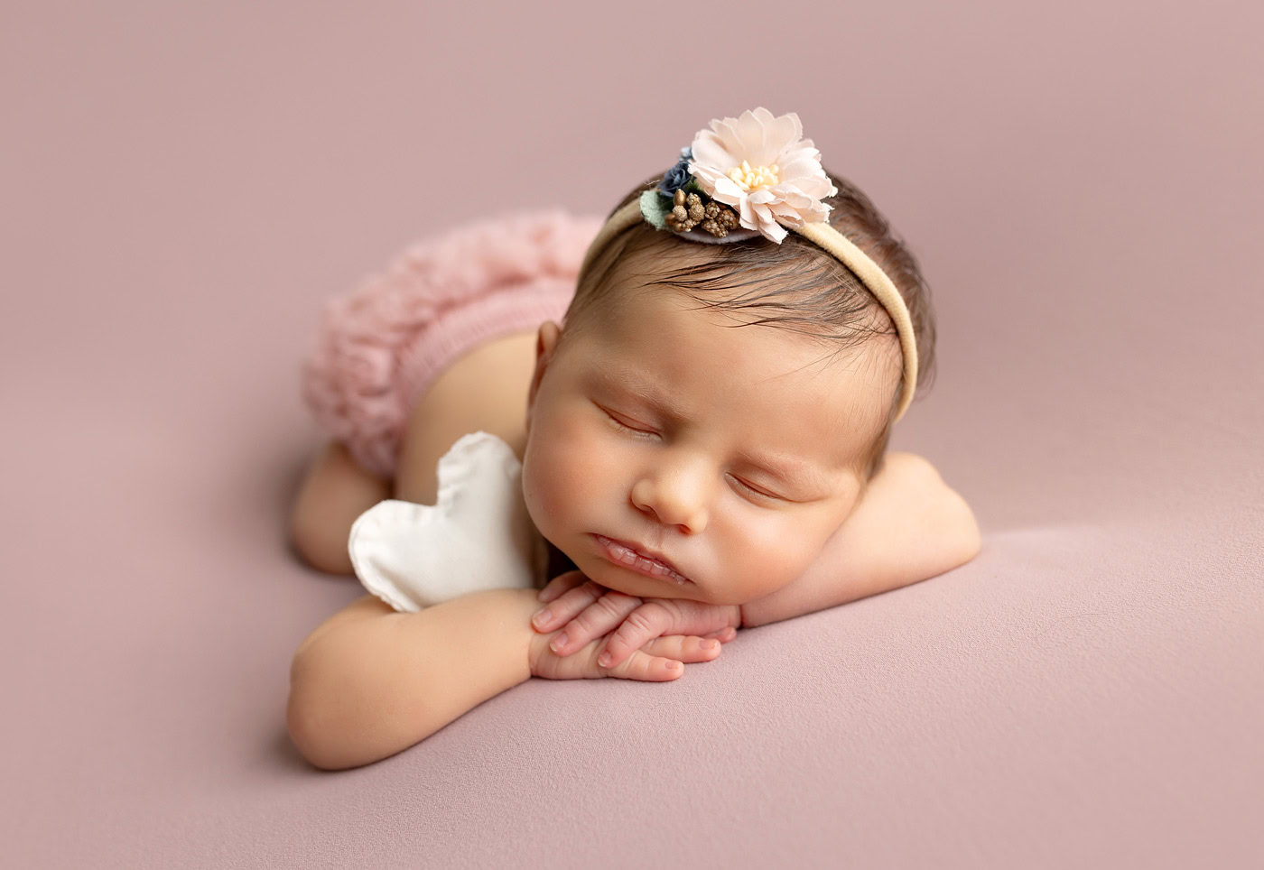 morris county nj newborn portraits newborn girl portraits in pink colors baby holding heart plush