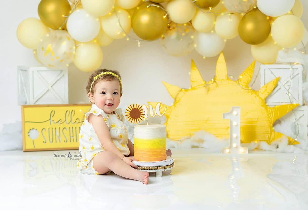 cake smash photo of baby girl in sunshine theme
