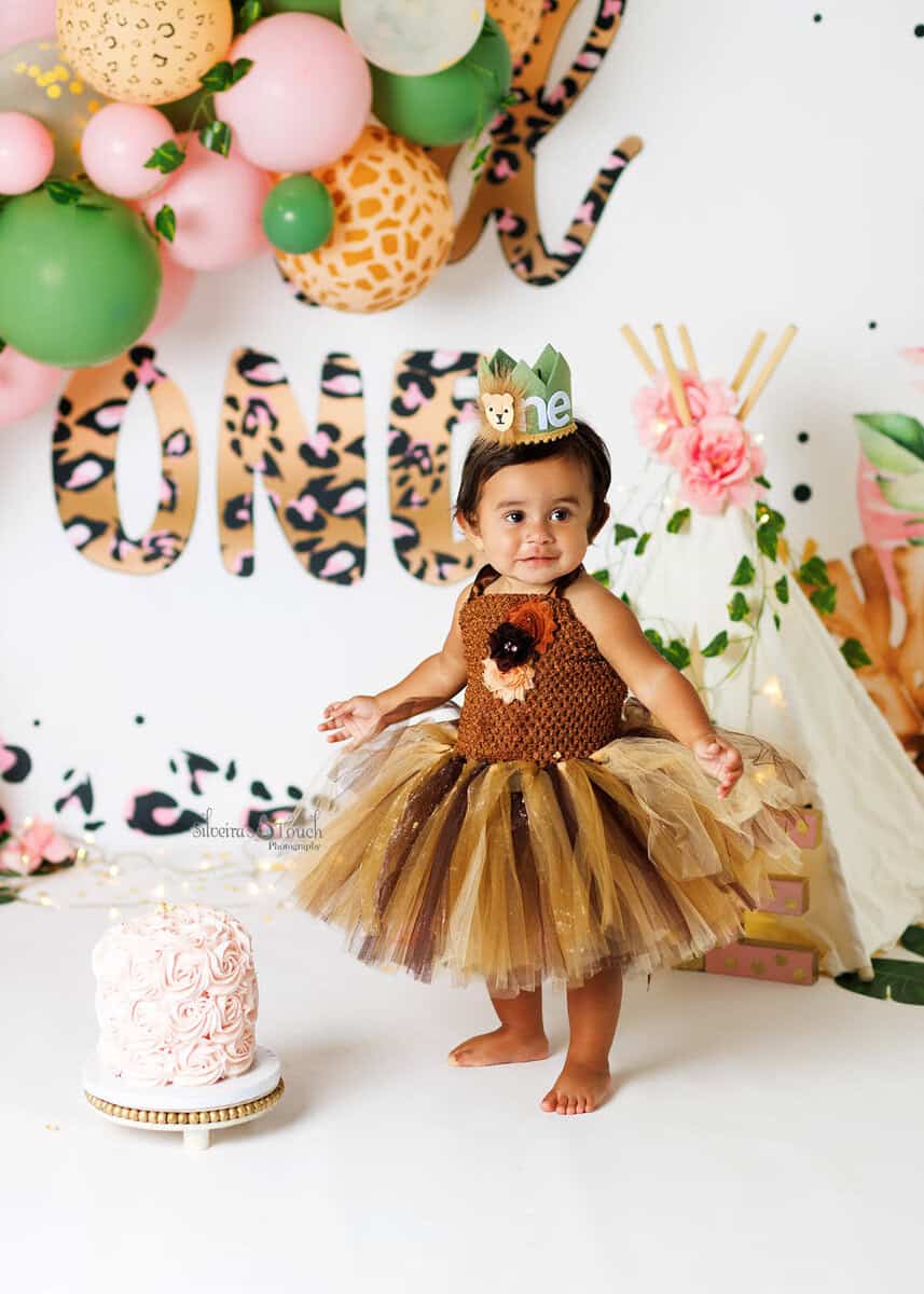 Luxury cake smash setup with balloons and safari accent for baby girl turning one