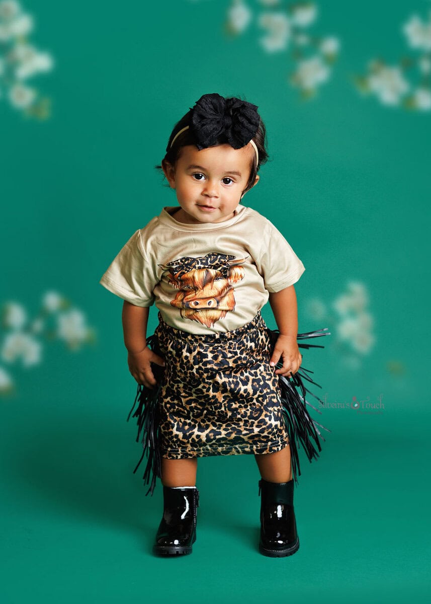 first birthday photo session with baby wearing safari outfit skirt
