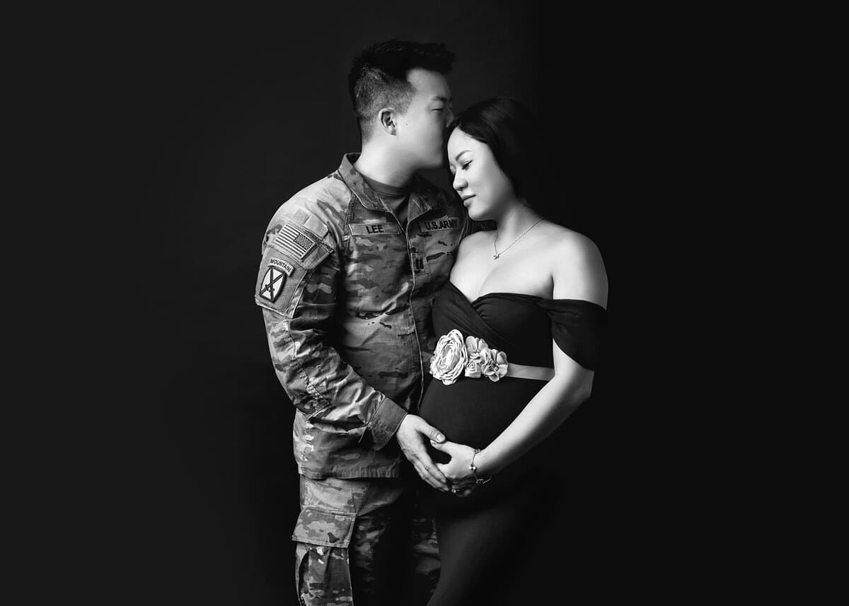 Black and white professional maternity photo session with couple holding baby bump in an intimate moment