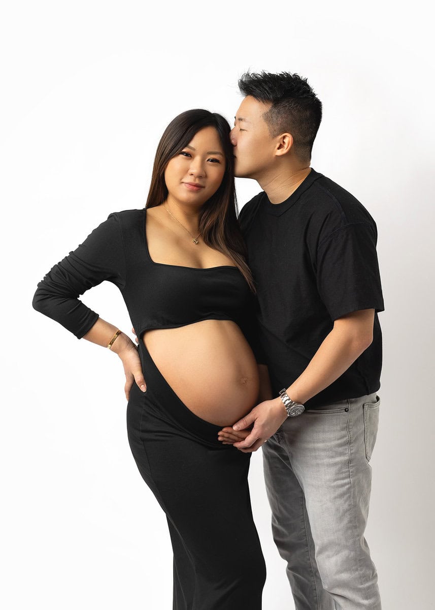 best maternity photography moment with expecting mom and ddad sharing a joyful connection