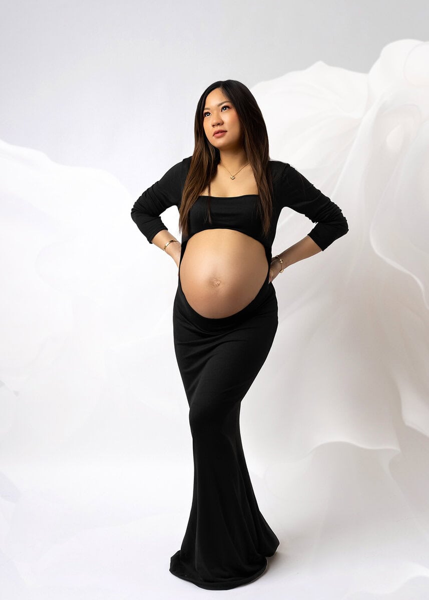 Luxury maternity wardrobe selection featuring elegant gown and accessories for photoshoot