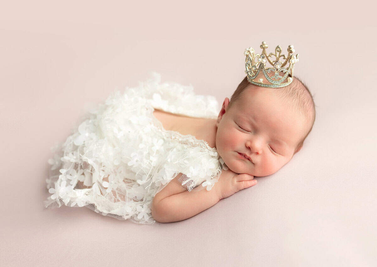 Pretty newborn baby girl wearing a tiny crown captured in Mount olive NJ by Silveira's Touch Photography